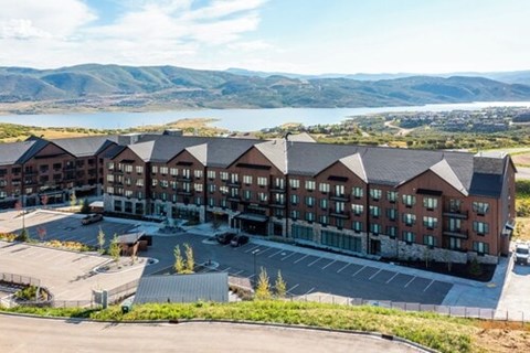 A large building with a parking lot in front of it.