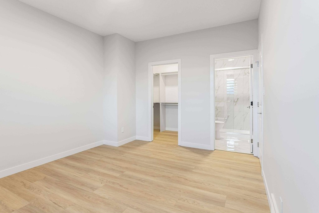 A room with a wooden floor and white walls.