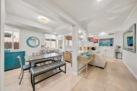 A modern kitchen with a dining table and chairs.