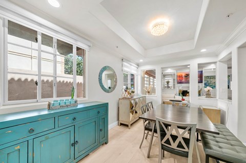 A dining room with a table and chairs.