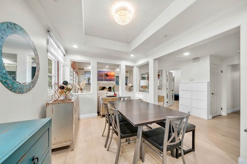 A dining room with a table and chairs.