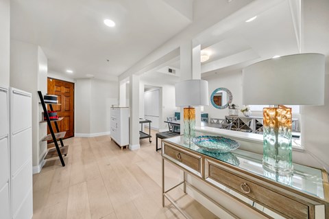 A modern kitchen with a wooden floor and white walls.