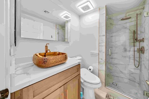 A bathroom with a toilet, sink, and shower.