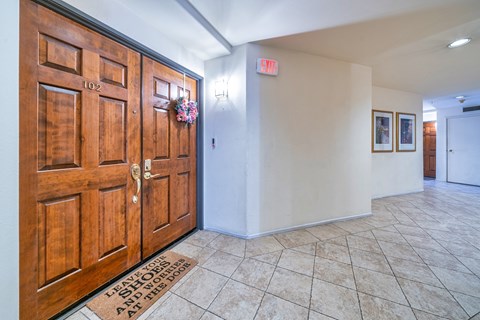 A wooden door with a sign on the wall above it.