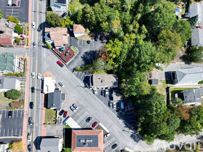 A top-down view of a street with cars and buildings.