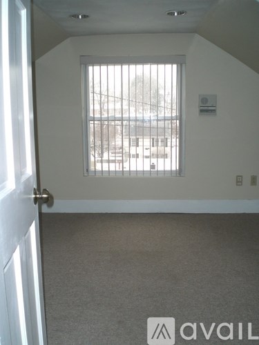 A room with a window and a door.