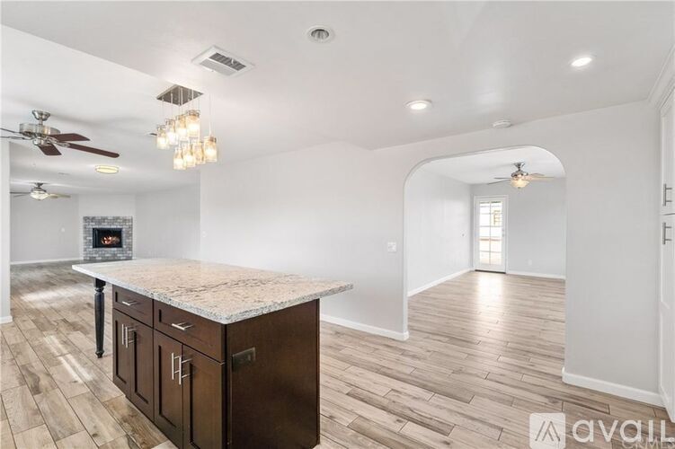 A kitchen with a marble countertop and a fireplace.