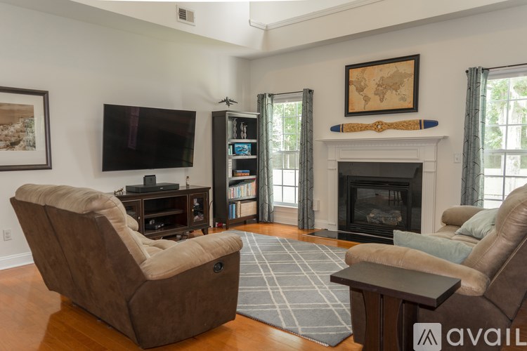A living room with a fireplace and a television.