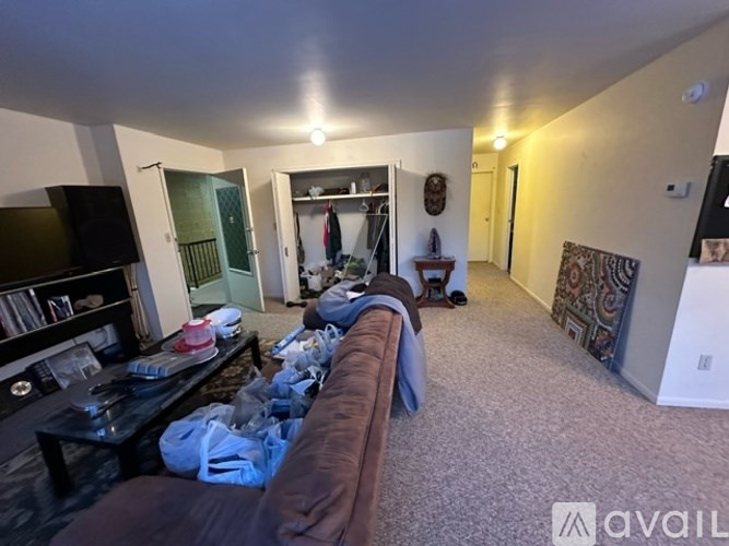 A living room with a brown couch and a television.