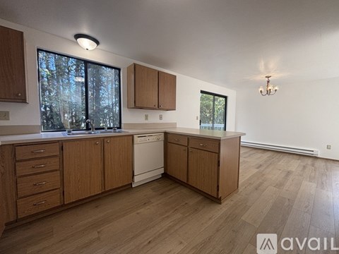 A kitchen with wooden cabinets and a washing machine.