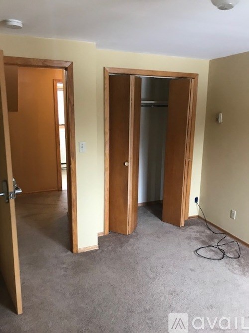 A room with two doors and a carpeted floor.