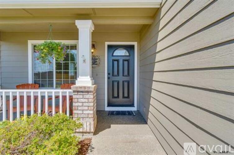 A house with a blue door and a white porch.