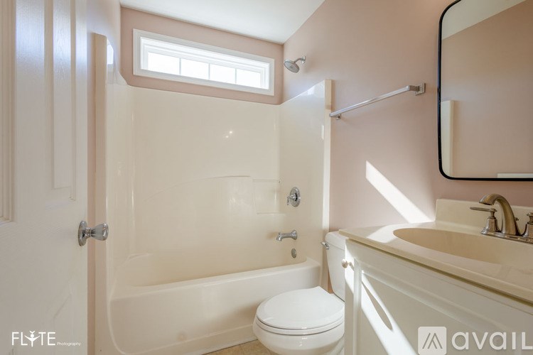 A bathroom with a toilet, sink, and bathtub.