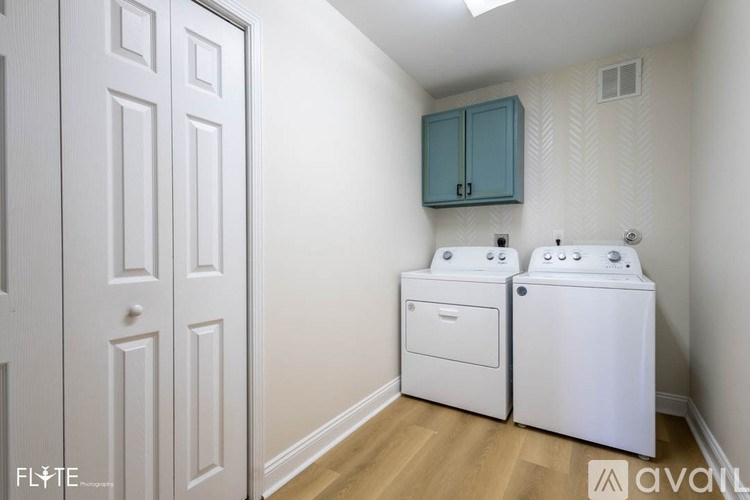 A small laundry room with a washer and dryer.