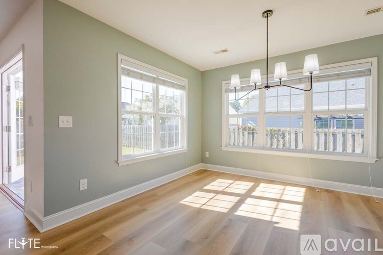 A room with a large window and a chandelier.