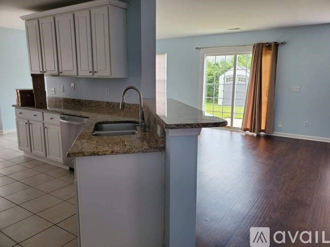 A kitchen with a granite countertop and a sink.