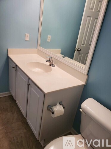 A bathroom with blue walls and a white sink.