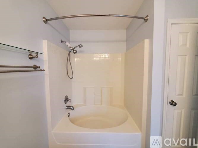 A white bathroom with a shower and a bathtub.