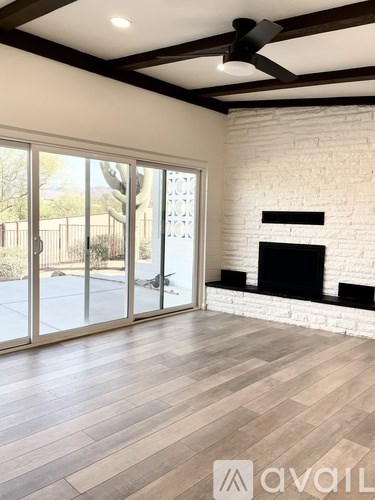 A room with a fireplace and a sliding glass door.