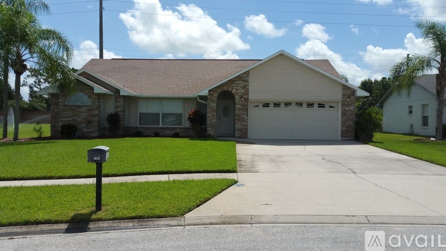 A house with a driveway and a mailbox in front.
