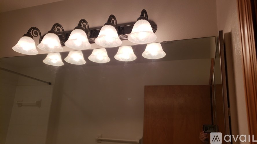 A row of lights are on in a dark room.