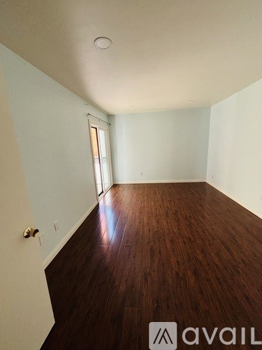 A room with wooden floors and white walls.