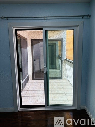 A room with a sliding door leading to a balcony.