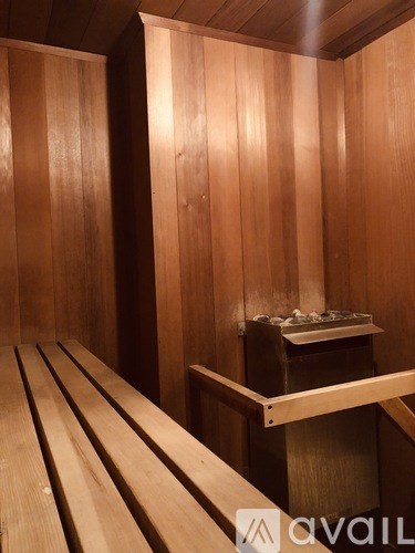 A wooden sauna with benches and a table.