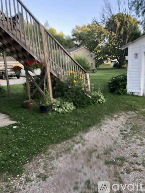 A metal railing with plants on the ground.