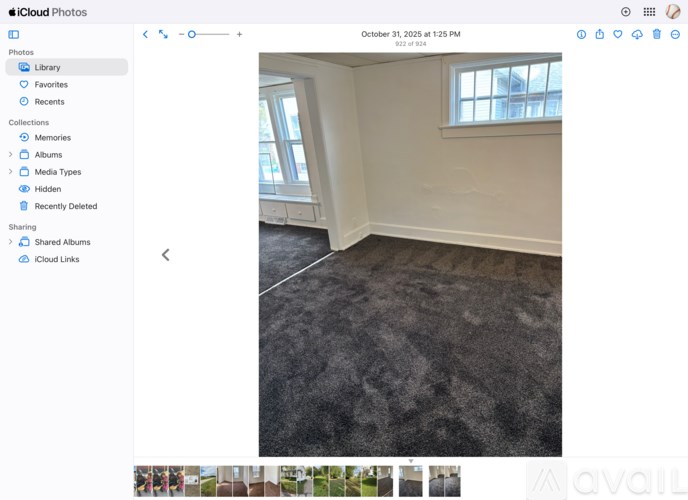 A room with a carpeted floor and a window.