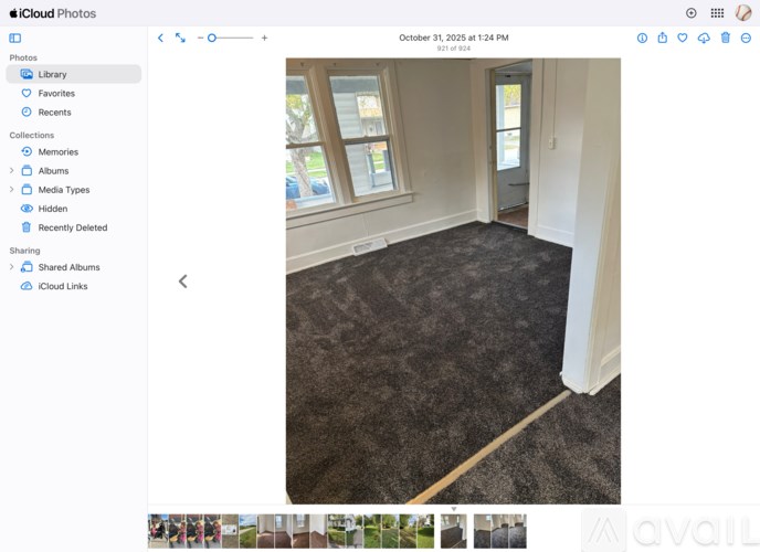 A room with a carpeted floor and a window.