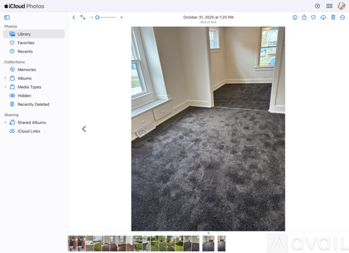 A room with a carpeted floor and a window.