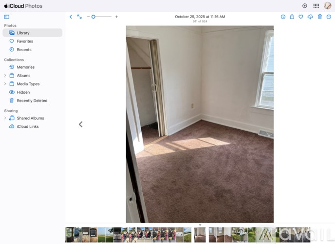 A room with a carpeted floor and a doorway leading to another room.