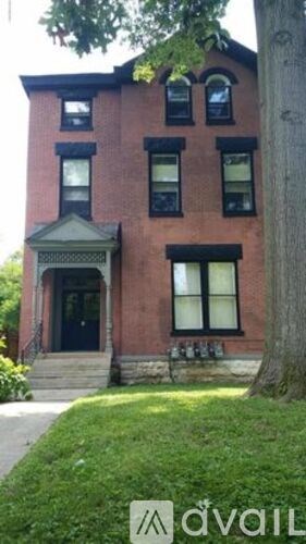 A red brick house with a black front door and windows.