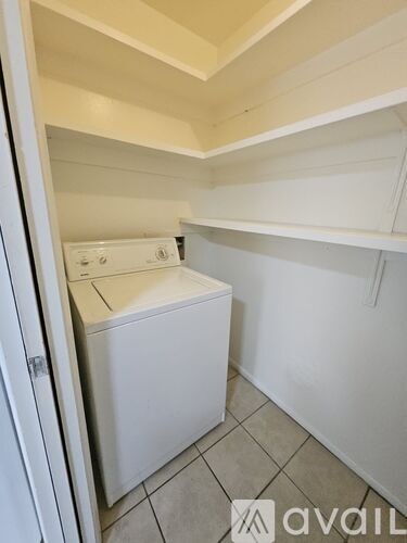 A small laundry room with a washer and dryer.
