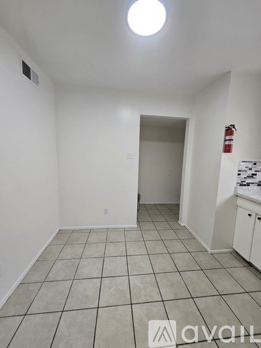 A room with white walls and a tiled floor.
