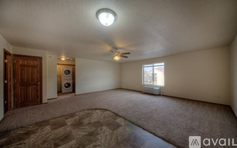 A room with a ceiling fan and a window.