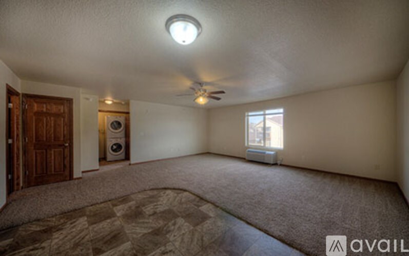 A room with a ceiling fan and a window.