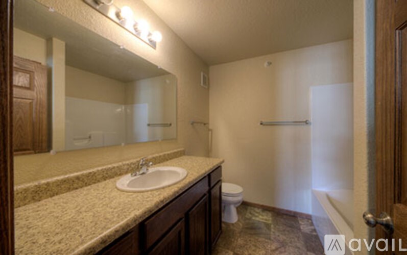 A bathroom with a sink, toilet, and shower.