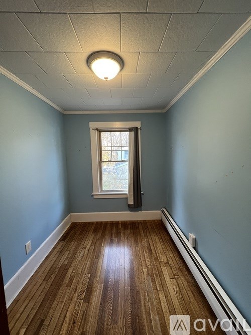 A room with wooden floors and a window.