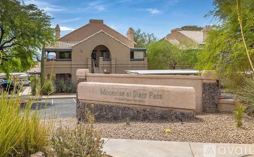 A sign that says Moonrise at Star Pass stands in front of a house.