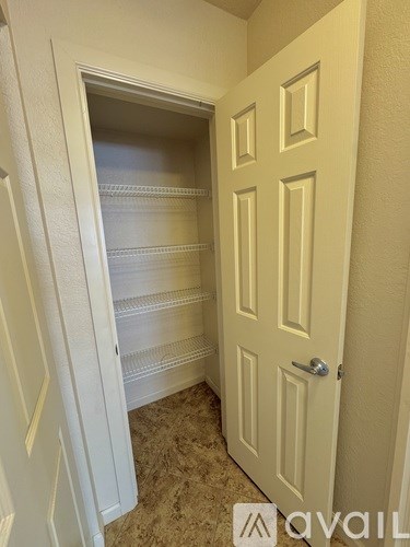 A white door with a handle and a window in the other side of the door.