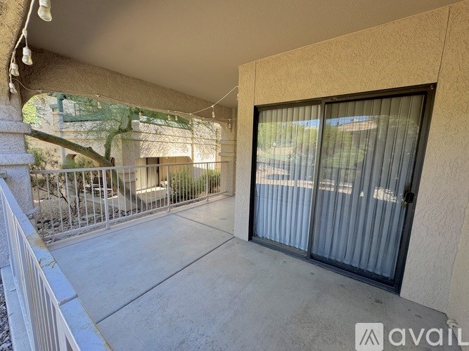 A balcony with a metal railing and a glass door.