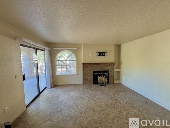 A living room with a fireplace and sliding glass doors.