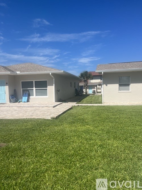 A sunny day at a residential area with houses and green lawns.