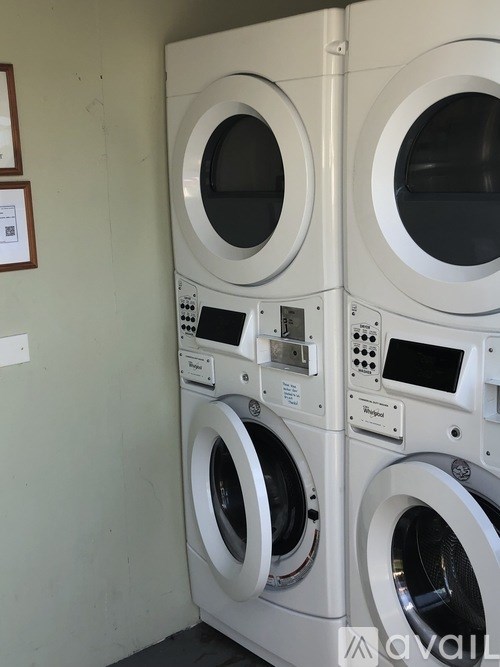 A stack of white front loading washing machines.