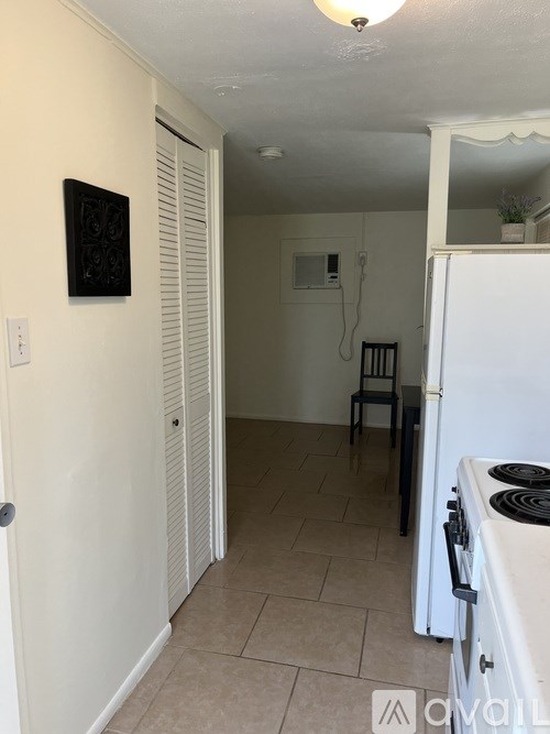 A kitchen with a white fridge and a white door.
