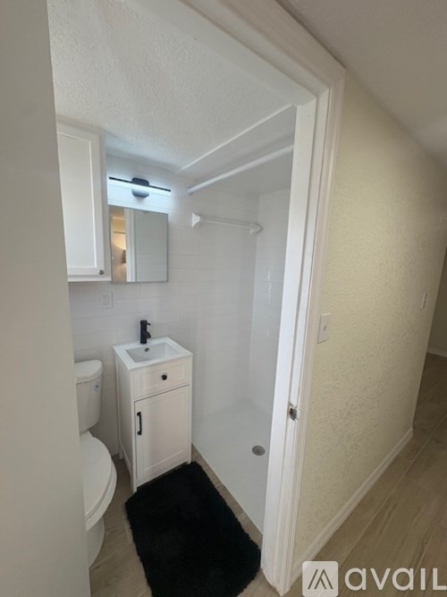 A white door with a black decorative plate on the wall.