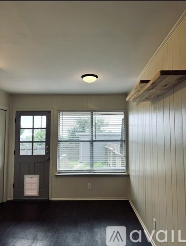 A room with a window and a door.