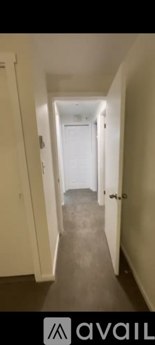 A long hallway with doors on both sides.